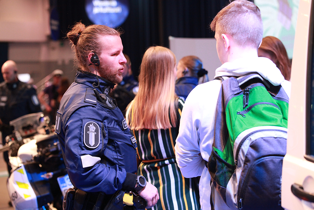 Poliisit juttelevat messukävijöiden kanssa.