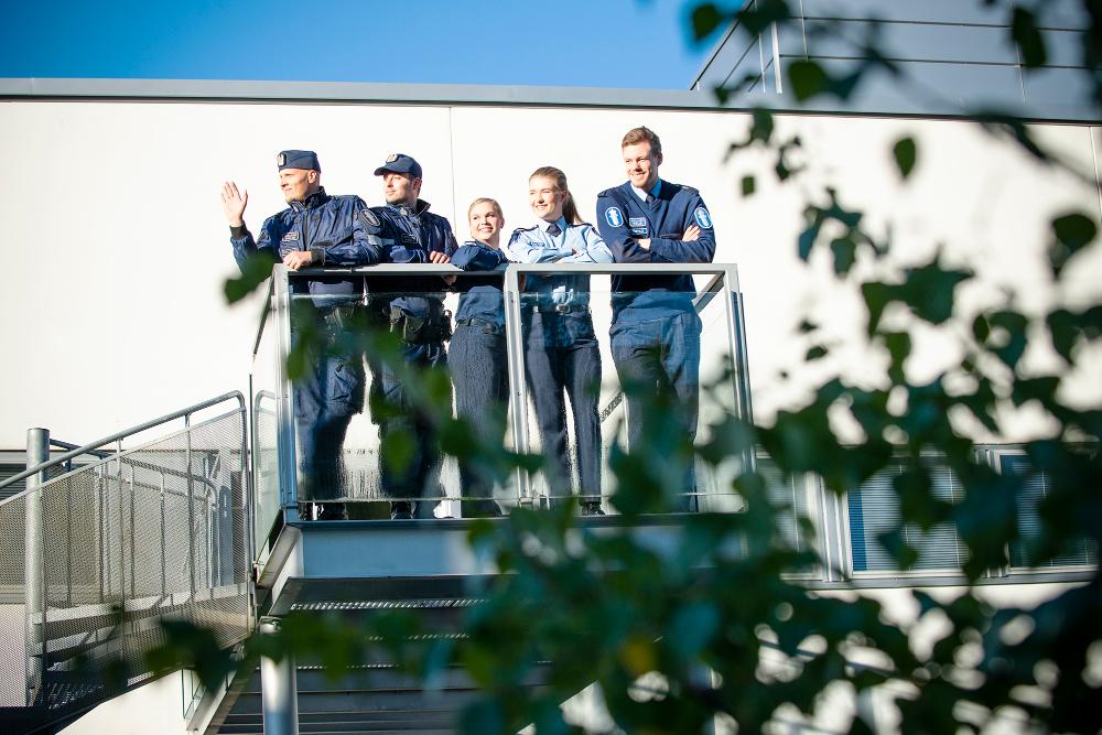 Police students on an outdoor balcony.